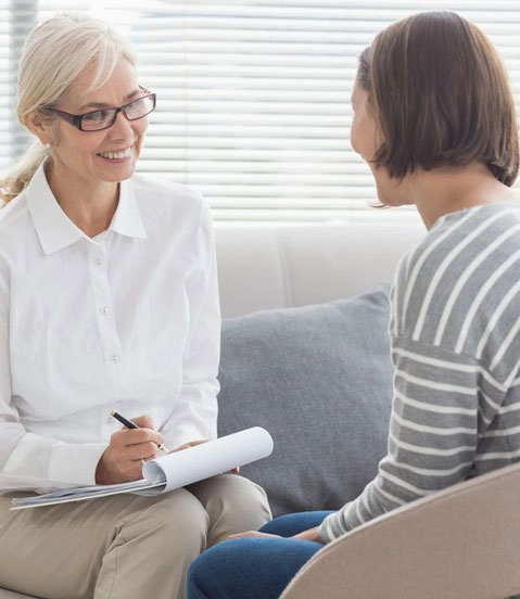 A woman sitting on the couch talking to someone