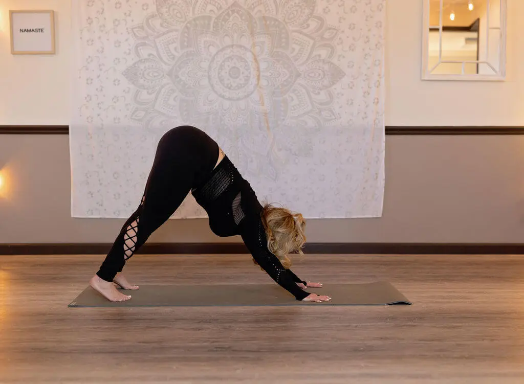 A woman is doing yoga on the floor